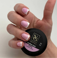 Nogtika Aufbau Gel Softy jar shown with French manicured nails demonstrating soft pink and white nail design
