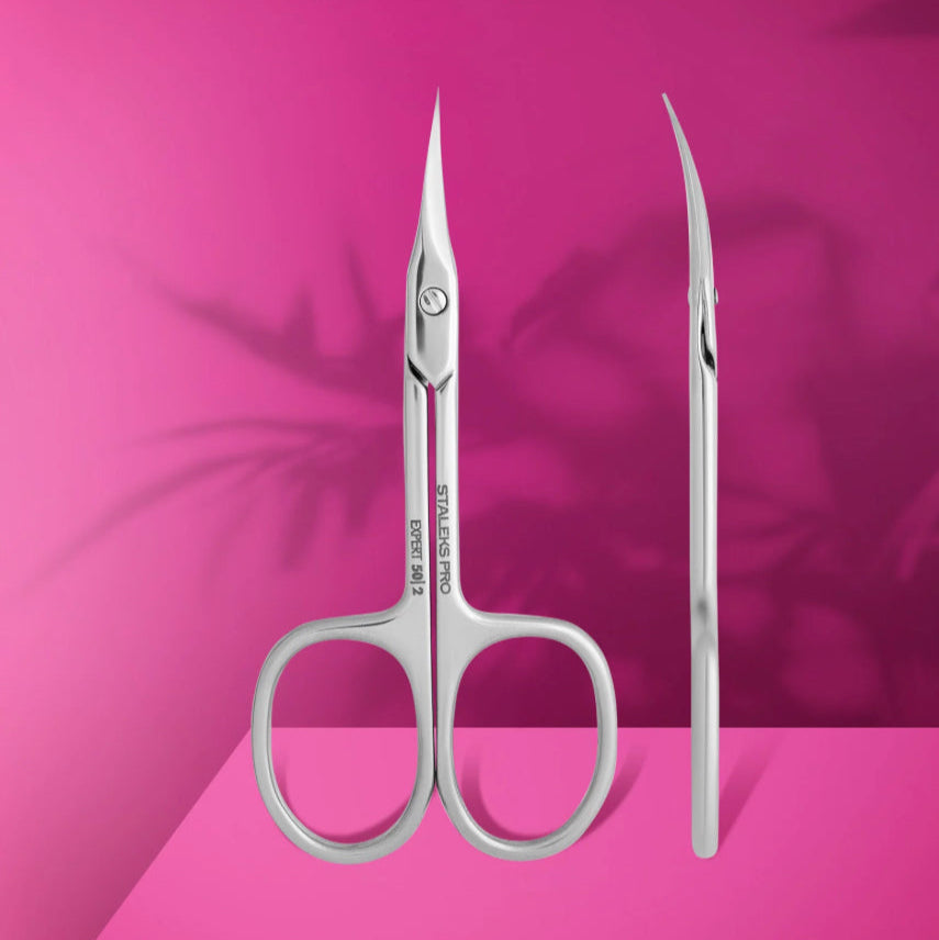 Professional cuticle scissors EXPERT 50 TYPE 2 with stainless steel blades and ergonomic handles on pink background